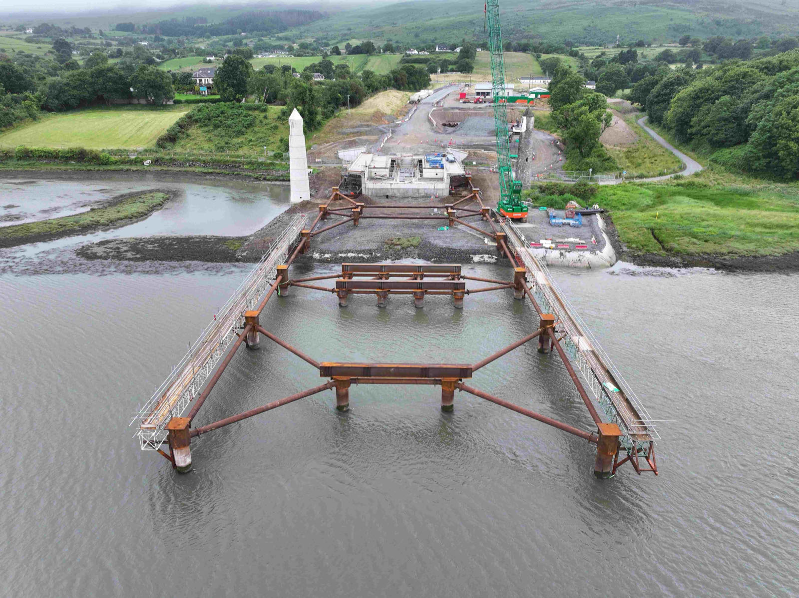 Aerial view of the 155-tonne steel skid track installed across the River Newry to the south abutment of the Narrow Water Bridge
